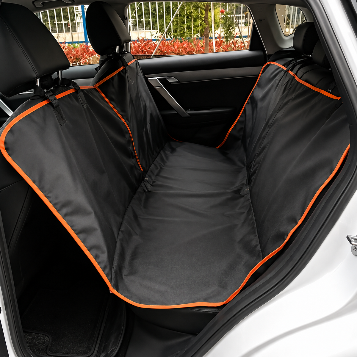 Dog Car Hammock fitted across a back bench seat, covering the footwell, with orange trim